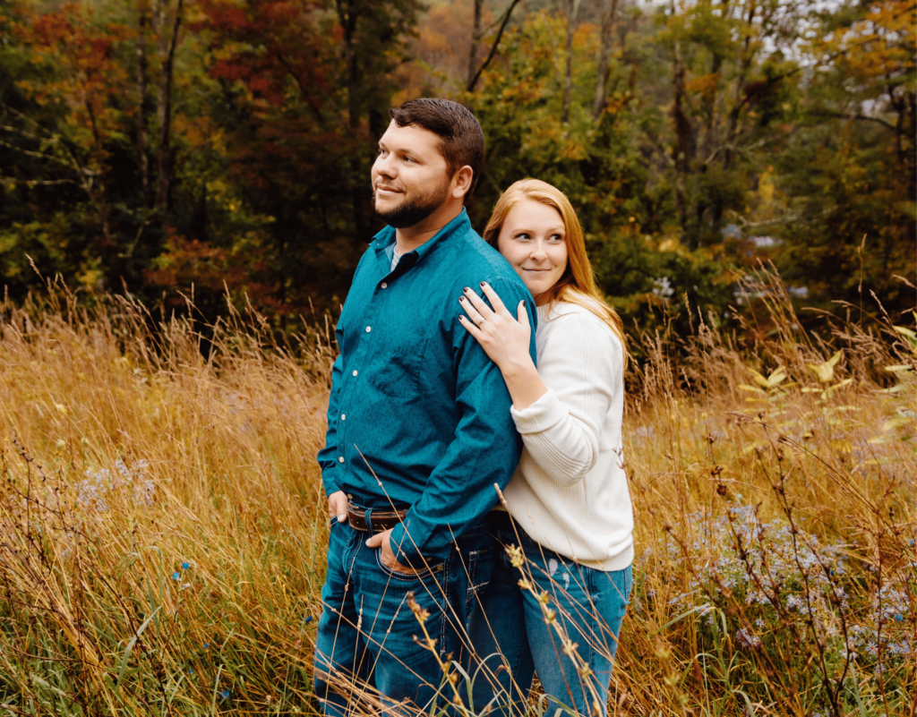 Fall engagement photo in field of tall grass